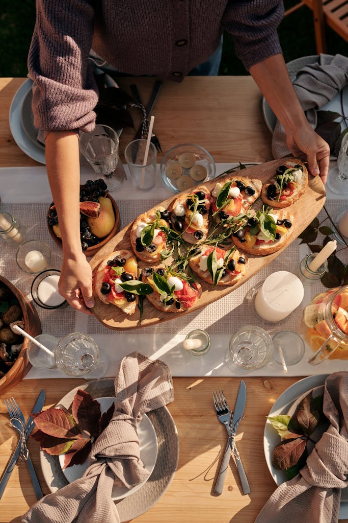 Top view of a gourmet dining table with elegant bruschetta served at a dinner party, ready for celebration.